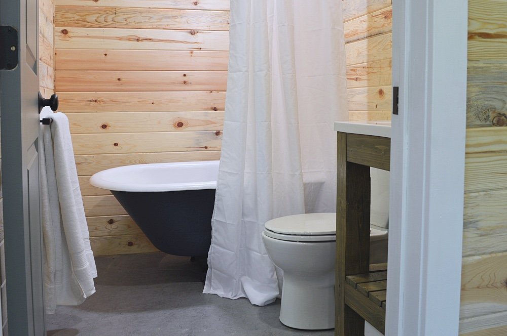 Tiny cabin in the woods with a clawfoot bathtub